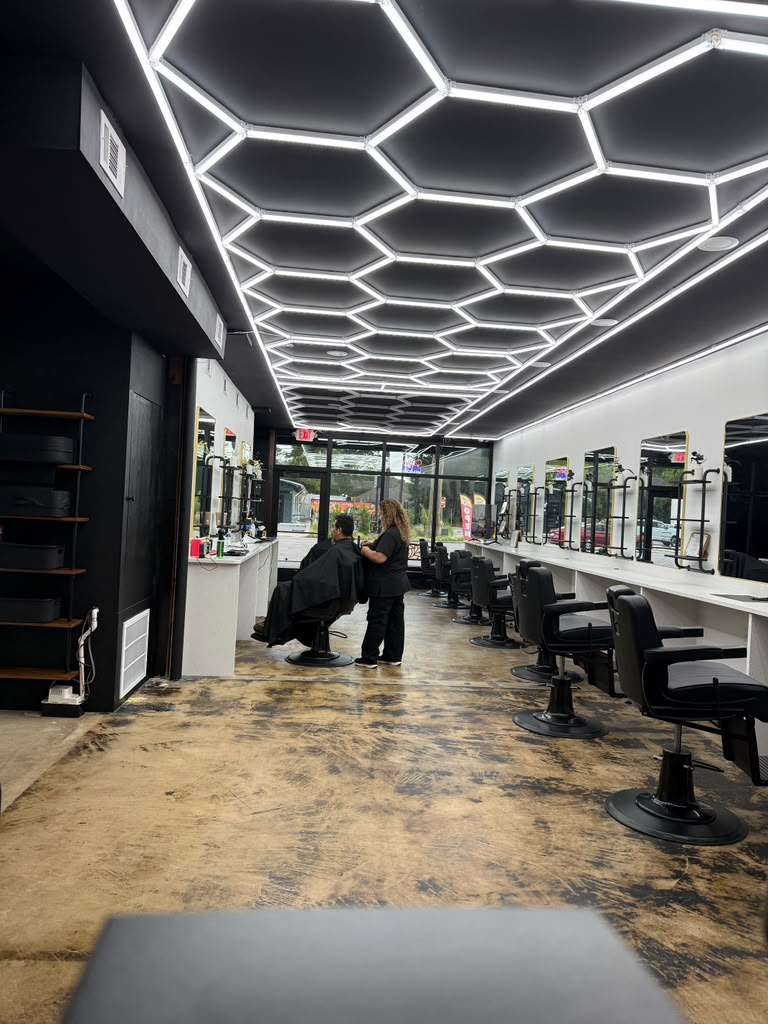 Interior of Blanca's Salon & Barbershop showing the honeycomb LED ceiling and styling stations